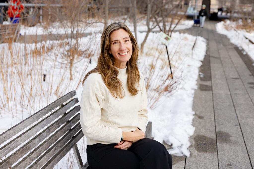 Kira Strong sits on a bench on the High Line