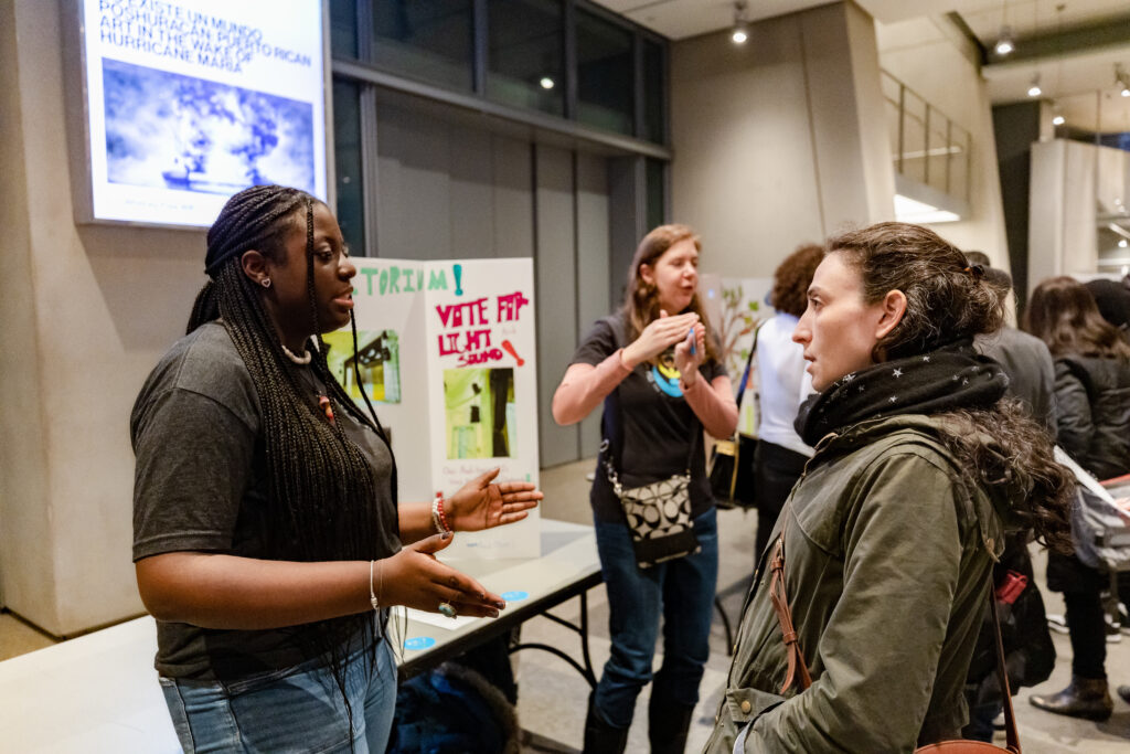 Kymberli Smith speaks with someone at a participatory budgeting meeting